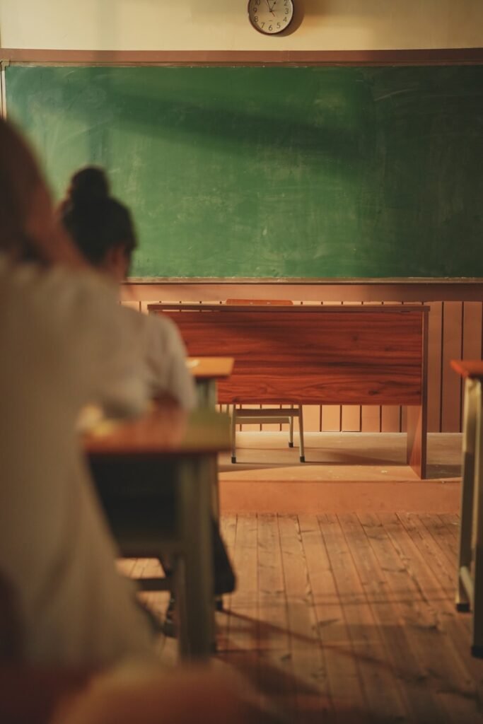 A group of people sitting at desks in a classroom ready to learn